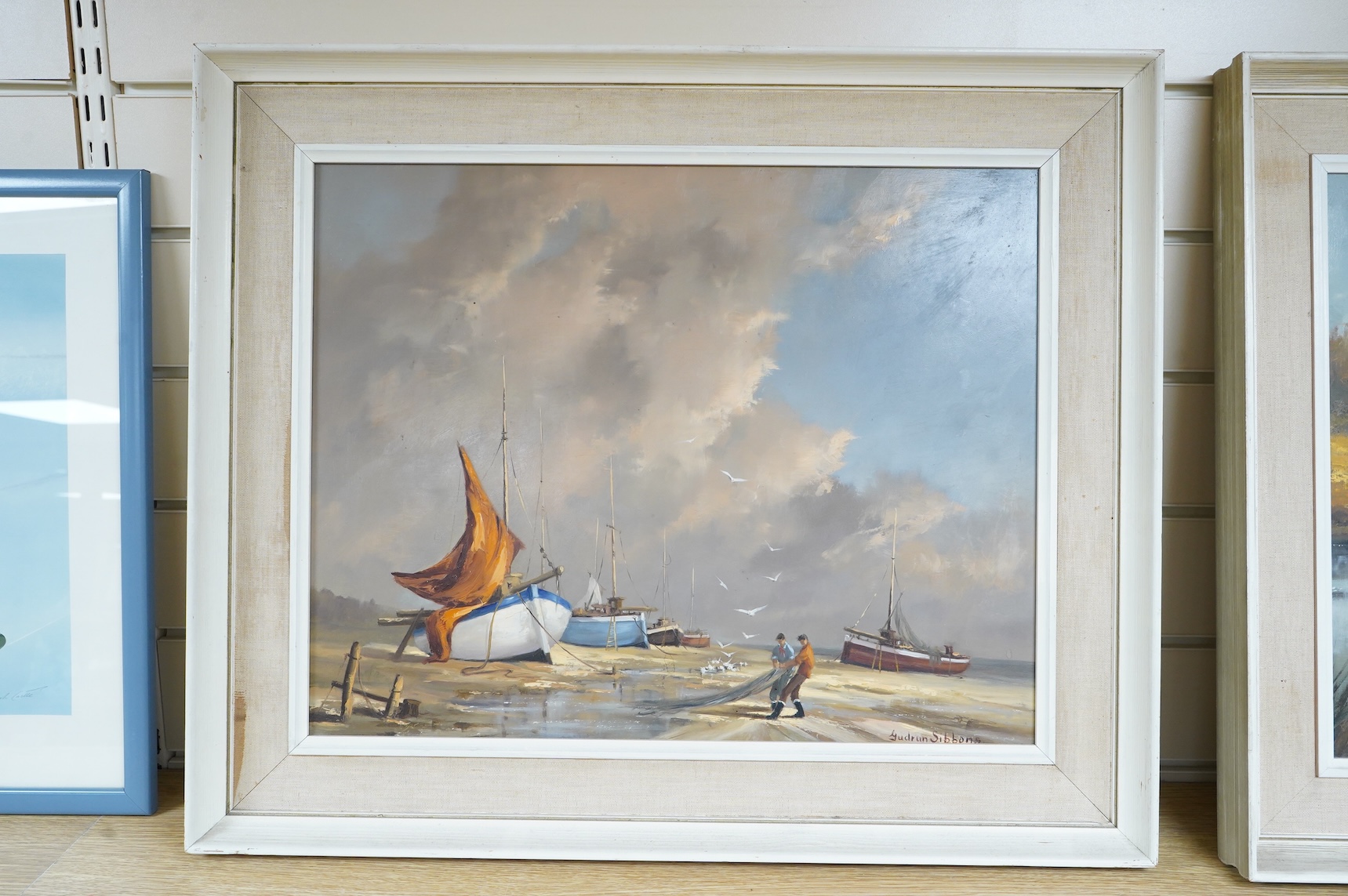 Gudrun Sibbons (1924-2020), Coastal view with beached fishing boats and fishermen, signed, oil on board, 39 x 49cm